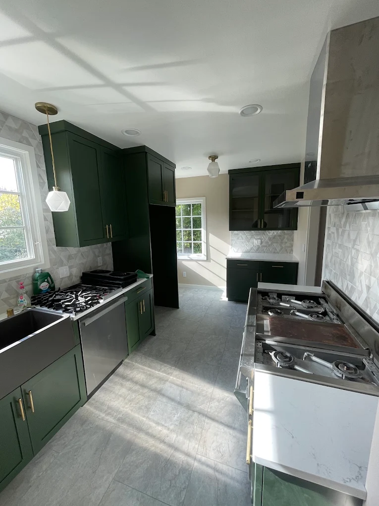 Emerald green kitchen remodel with brass hardware