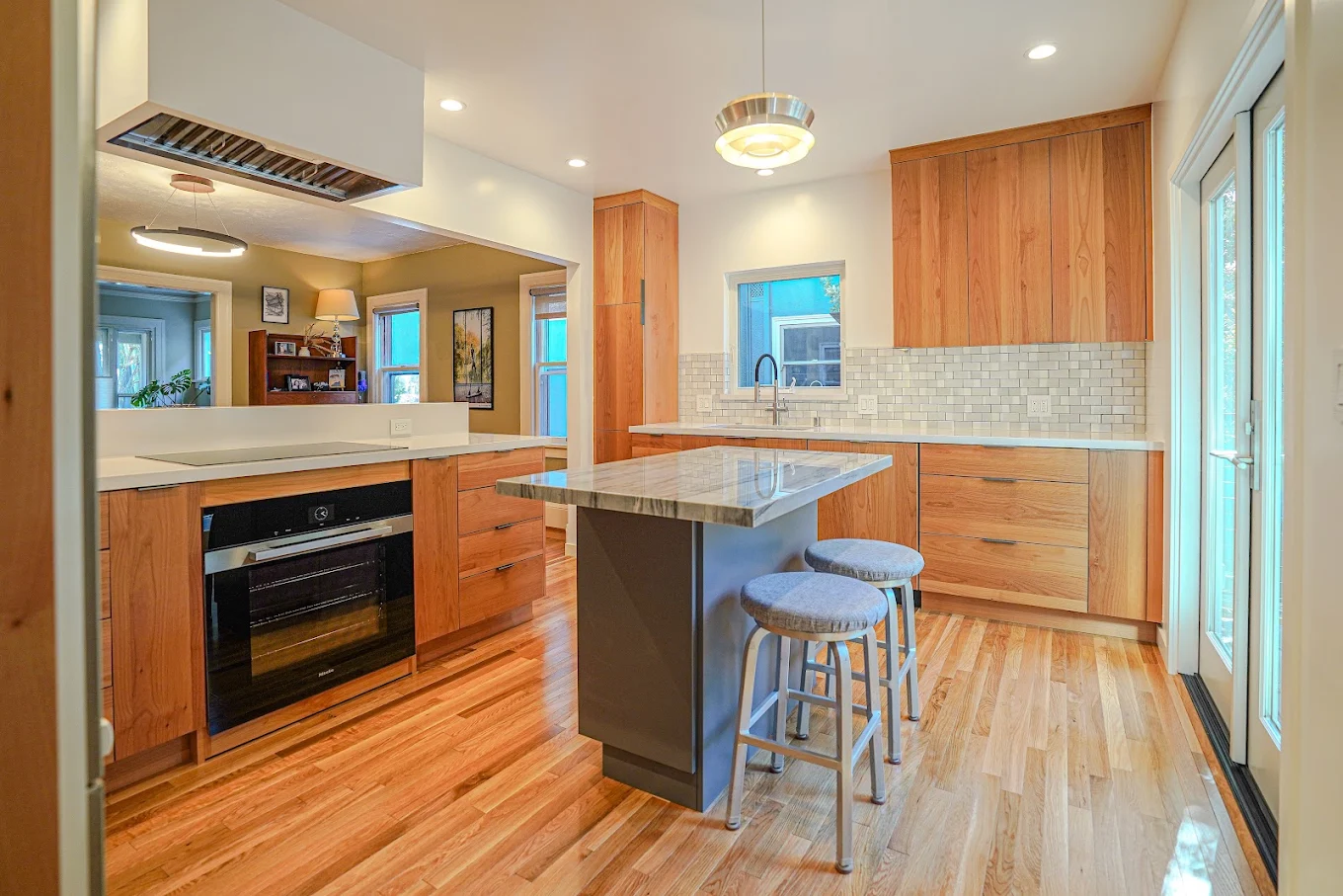 Kitchen remodel with marble island and pendant lighting